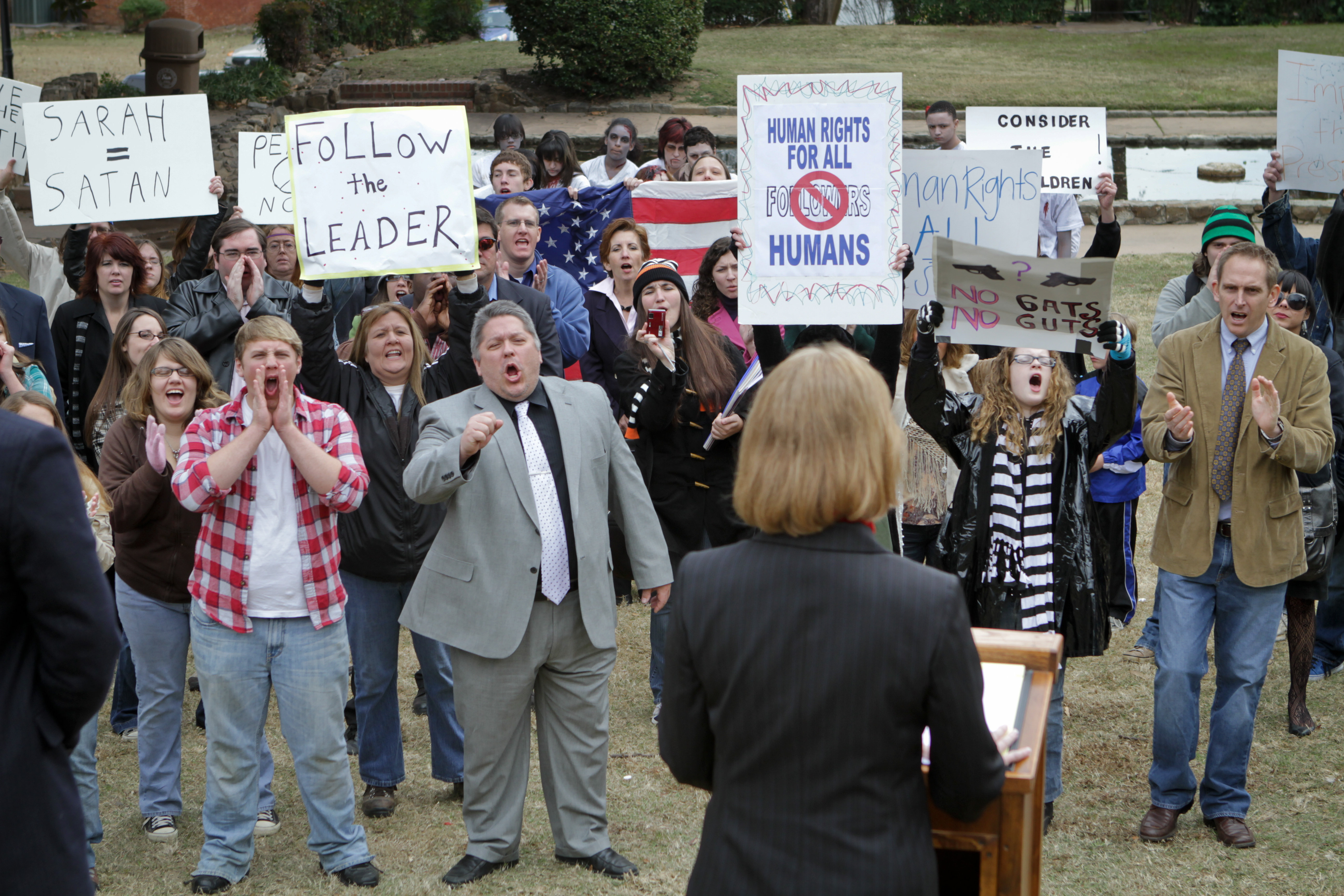 Congresswoman Sarah Thatcher (September Carter) addresses an angry mob of protesters and supporters in JamesWorks Entertainment's FOLLOWED.