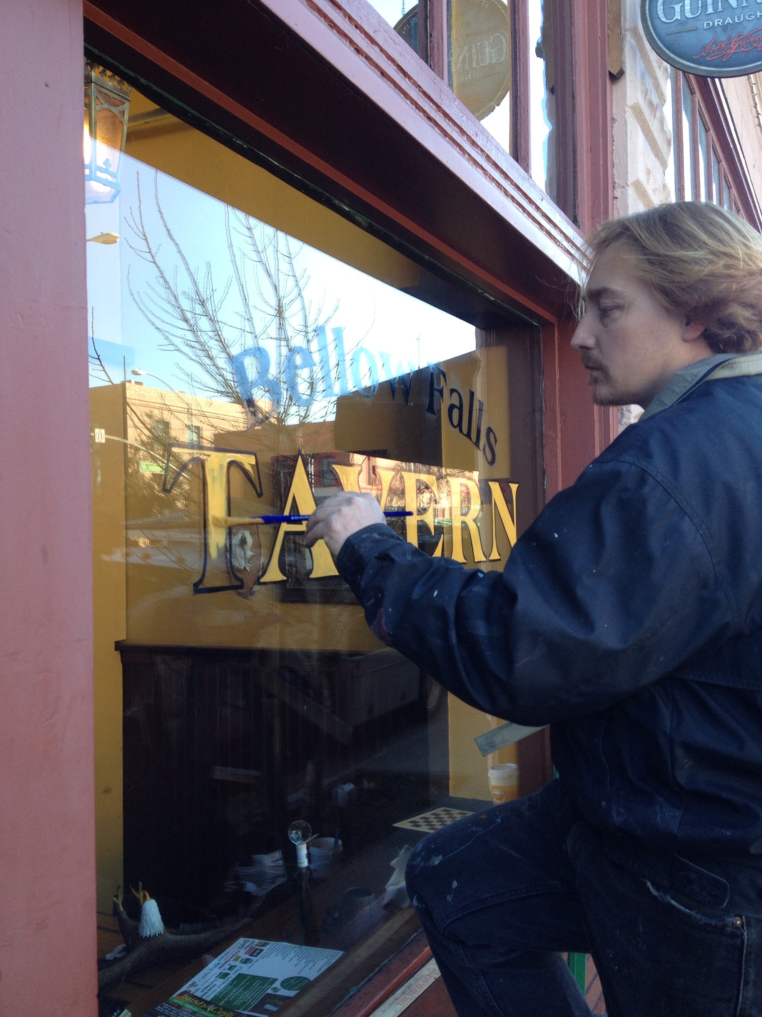 Kevin Signwriting a bar window for 