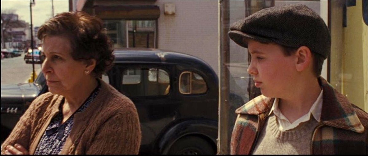 Young Irving Rosenfeld is disappointed in mother who won't help father in trouble. AMERICAN HUSTLE flashback scene.