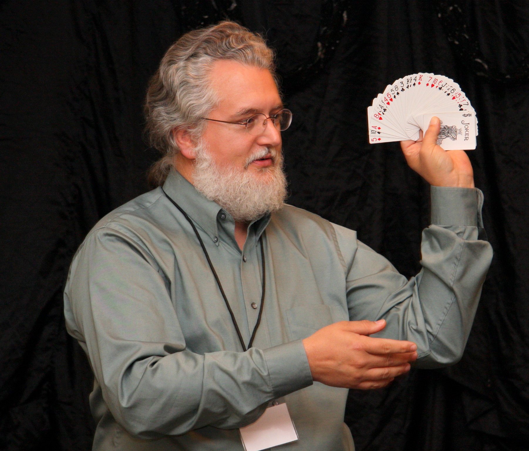 Mark Connelly Wilson performs a card trick during a lecture.