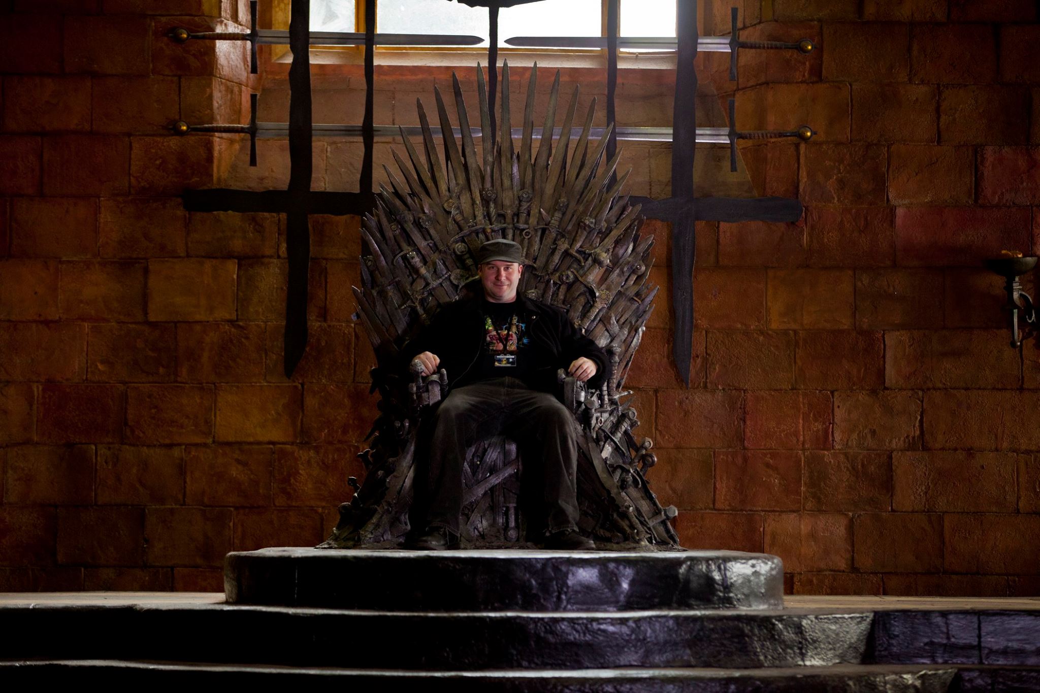 Jack Bennett seated on The Iron Throne on the set of HBO's GAME OF THRONES.
