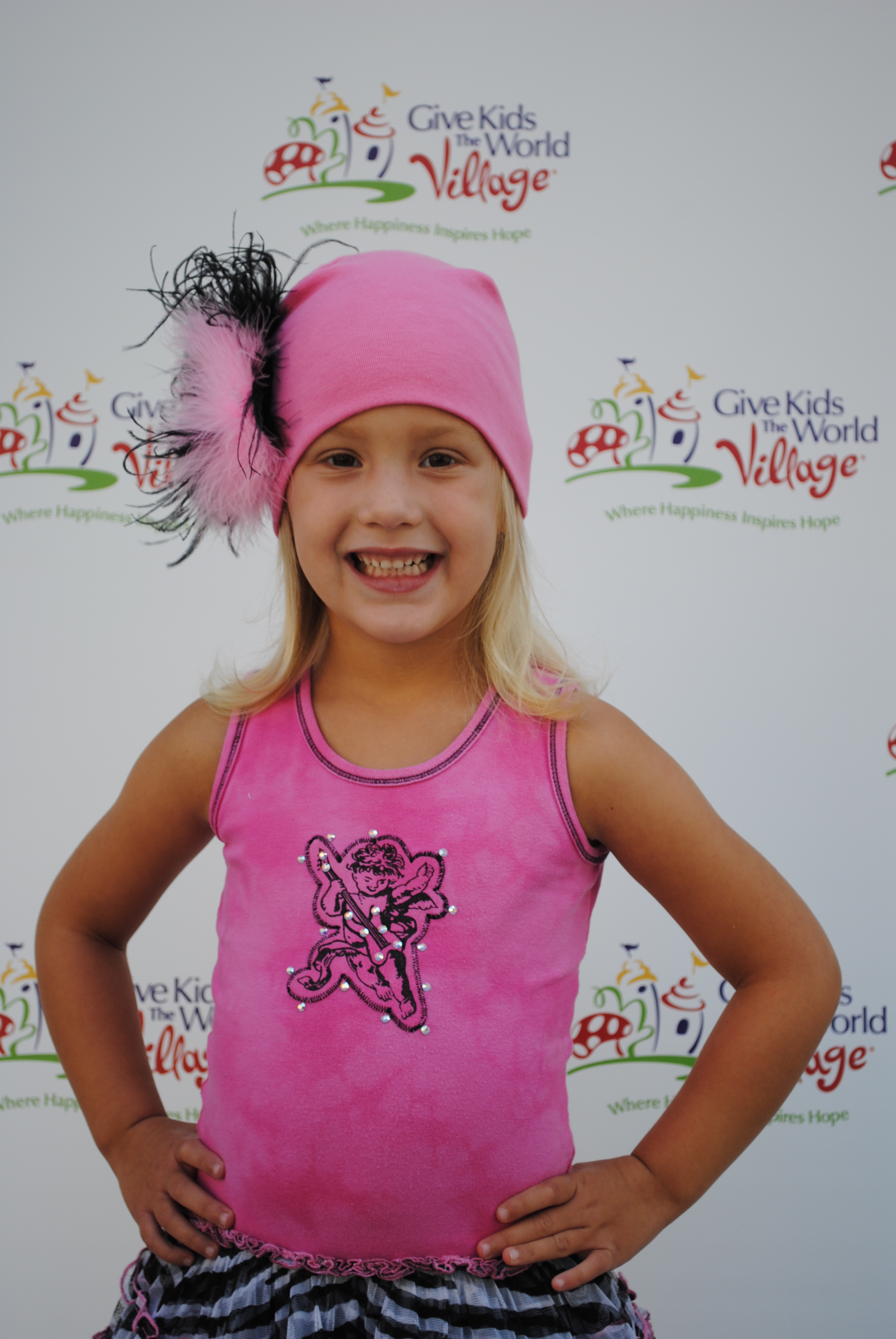 Natalia on the red carpet wearing Ooh! La,La! Couture and a Jamie Rae Hat at the Ice Cream for Breakfast Give Kids the World Village event.