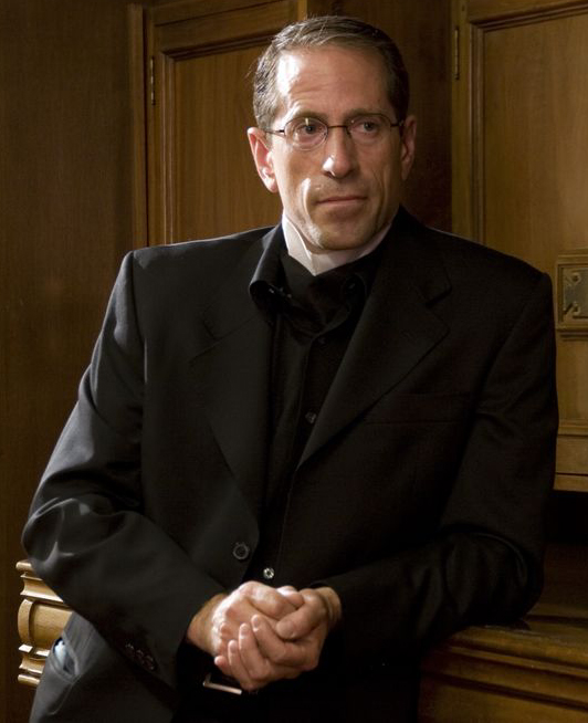 Montgomery Paulsen as The Choir Director in Contractor's Routine