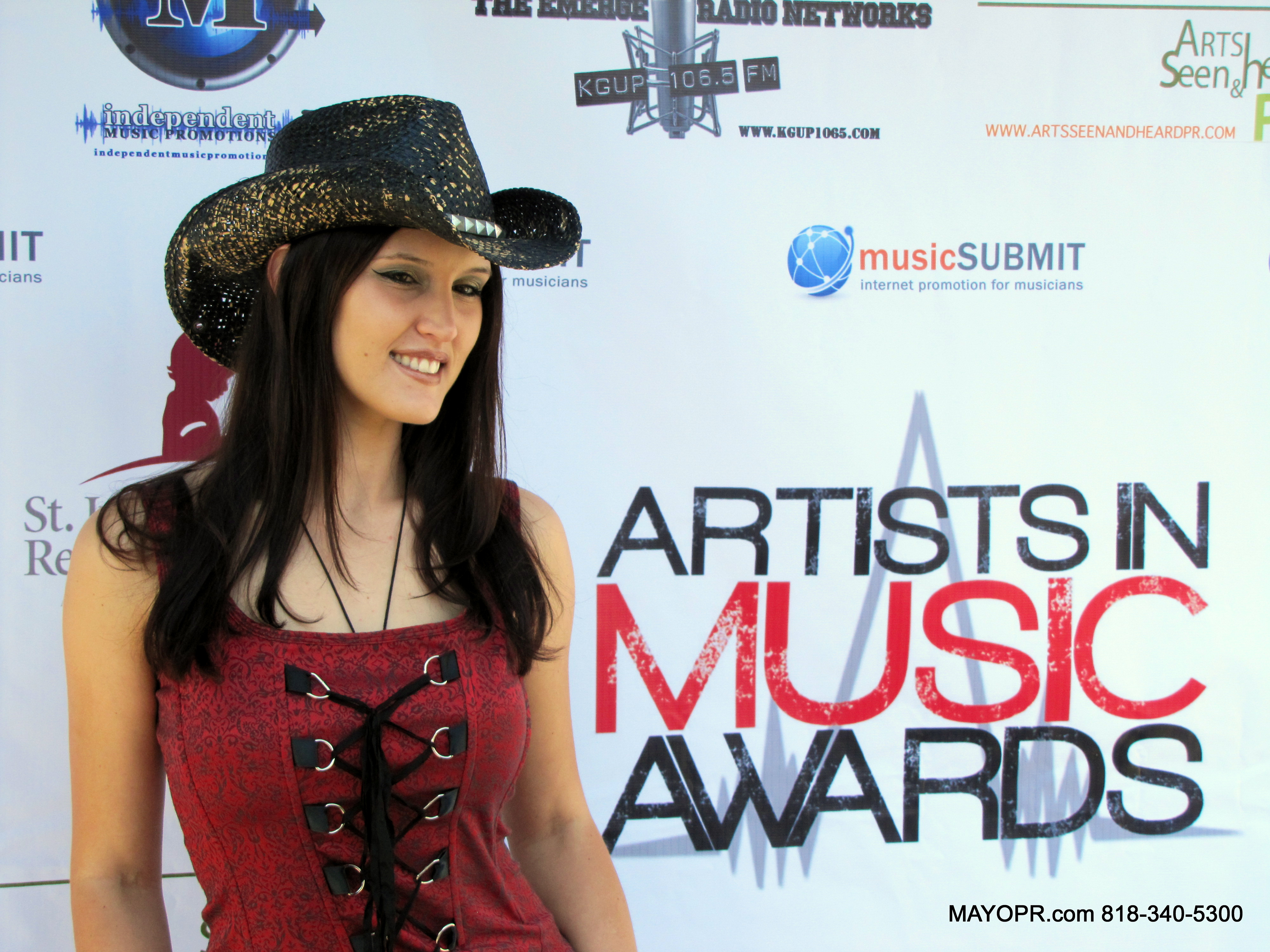 Best Country Western Singer/Songwriter and 2014 Artists In Music Awards nominee on the red carpet at a celebrity charity benefit in Hollywood, CA.