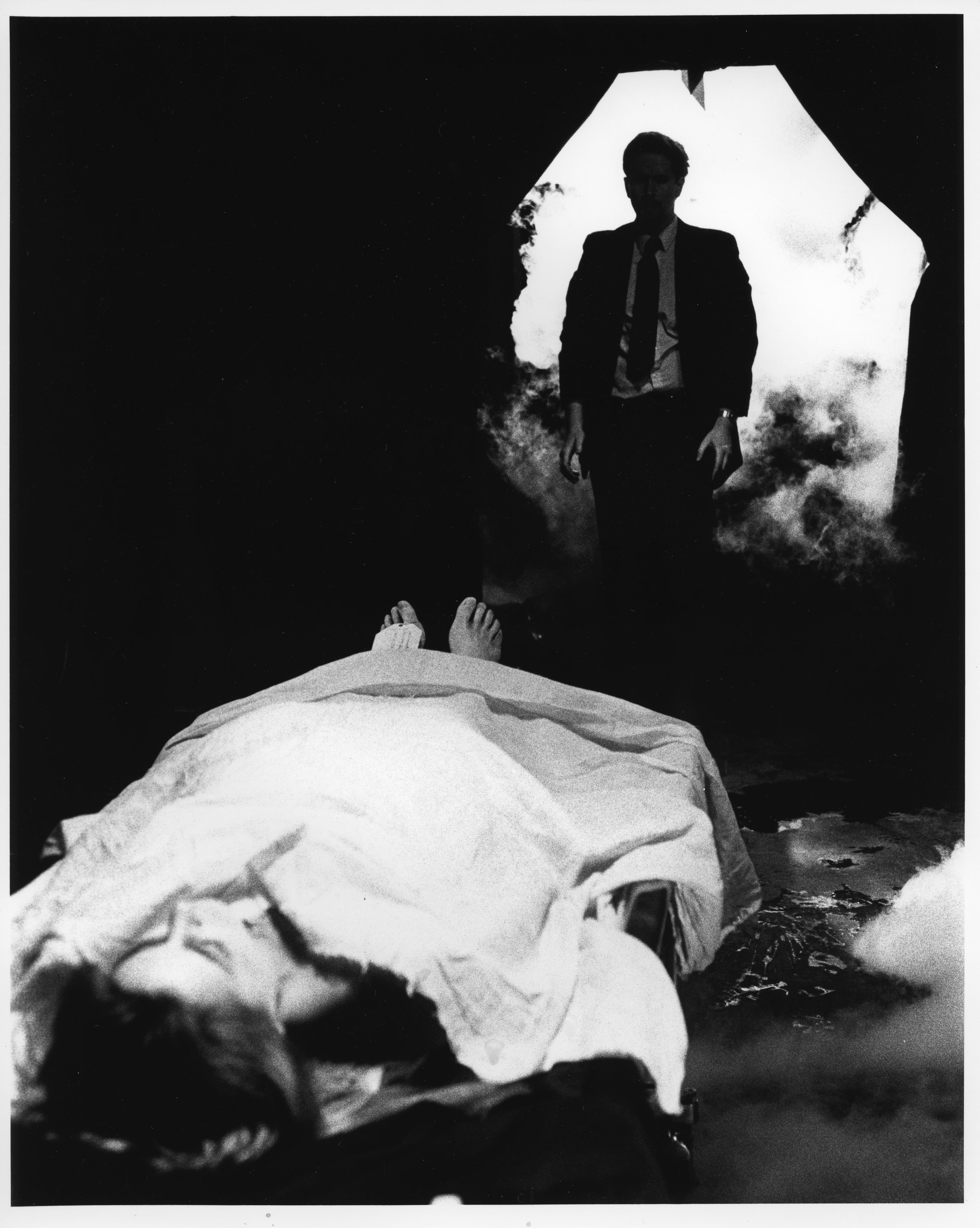 Zeno (Angel Connell) gazes at the toe-tagged corpse of his lover Marsha Morgan (Zenobia) as it lies inside the mysterious fog-shrouded room of the Morgan family mortuary in a scene from filmmaker Angel Connell's 