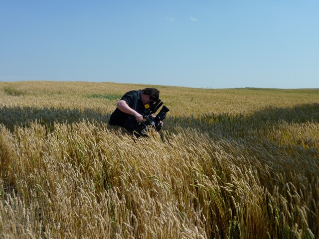 Sergio Olivares shooting in Canadian wheat field.