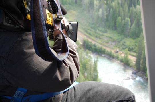 Sergio Olivares shooting Canadian Rocky Mountains from helicopter.