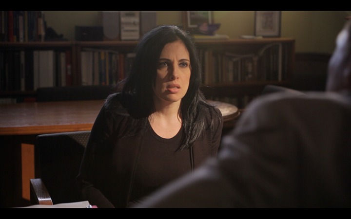 Janine Laino as Agent Scott deals with Assemblyman Dean Batta (Tom Sizemore) during a tense conversation