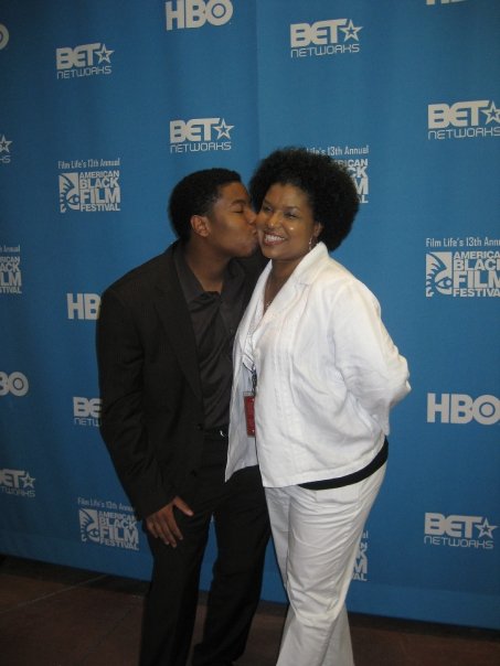 Kiel Adrian Scott kissing mother, Cara Harrison, after winning the HBO Short Film Competition.