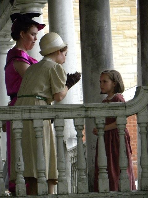 Miss Lillian (Keri Maletto) and Mrs Pryor (Maria Olsen) speaking with Esther (Nora Hoyle) in a scene from Gore Orphanage.