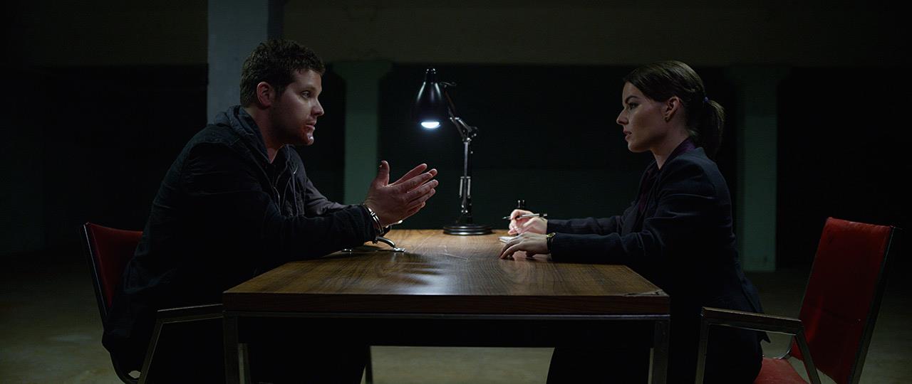 Agent Wilburn (Keri Maletto) interrogates Sean (Jeremy Palko) in So Dark, a film by Alan Lougher for Stage5 TV