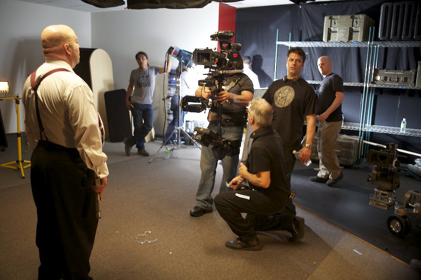 Director Paul Baker lines up a shot on actor David H. Lawrence XVII on the set of web series 