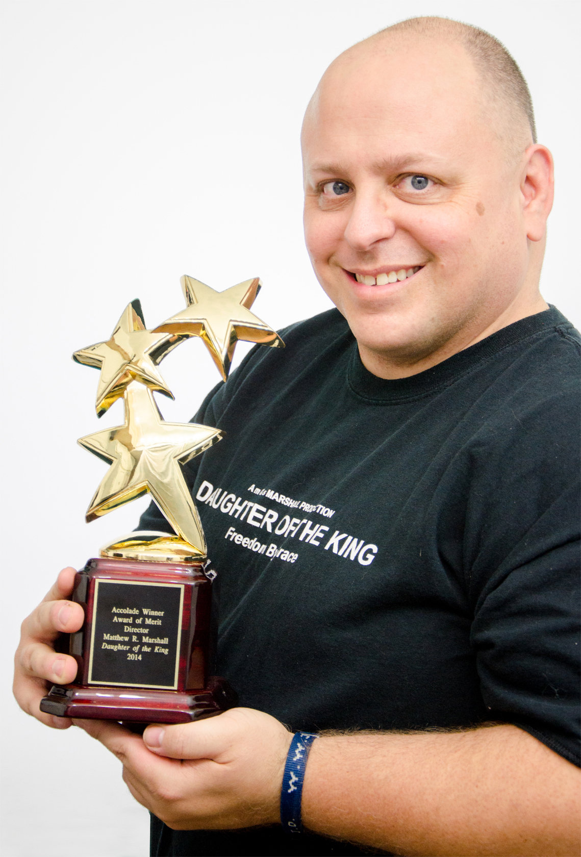 Matthew Marshall with his 2014 Accolade Global Film Competition Award of Merit: Director for Daughter of the King. The independent dramatic production won two other 2014 Accolade Global Film Competition Awards. The production won an Award of Merit: Christian Film and Debra van Gaalen won Award of Merit: Leading Actress for her role as Ashley Miller.