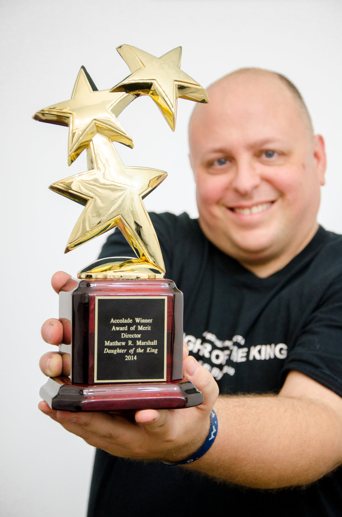 Matthew Marshall with his 2014 Accolade Global Film Competition Award of Merit: Director for Daughter of the King. The independent dramatic production won two other 2014 Accolade Global Film Competition Awards. The production won an Award of Merit: Christian Film and Debra van Gaalen won Award of Merit: Leading Actress for her role as Ashley Miller.