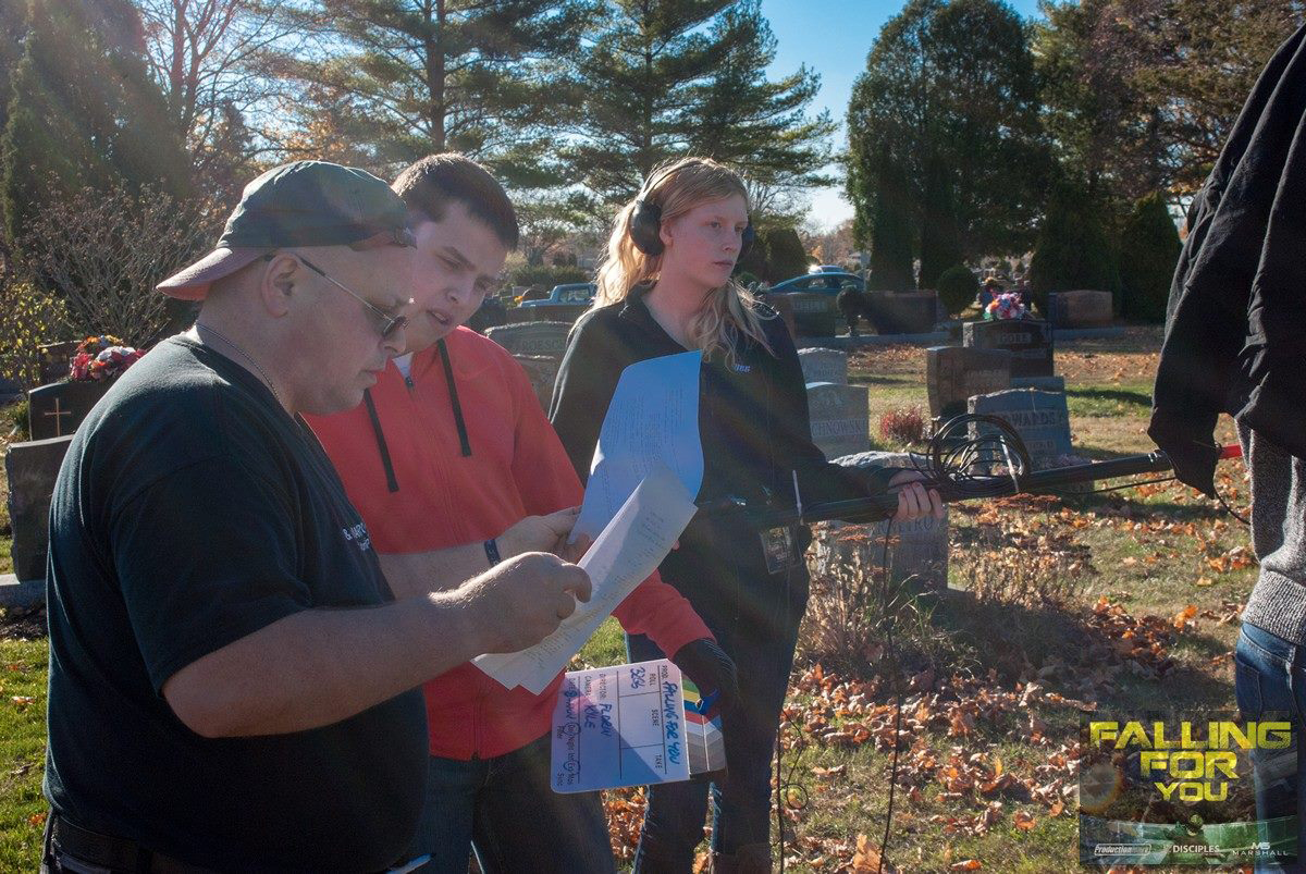Matthew on set of Falling For You for the funeral scene as 1st AD helping the crew review requirements for the upcoming shot.