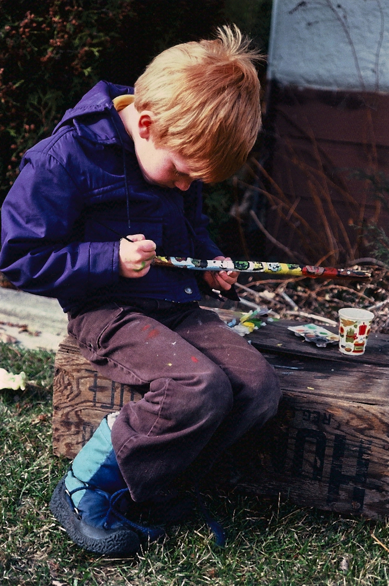 A young artist painting monsters in oil, a totem. Heath Tait.