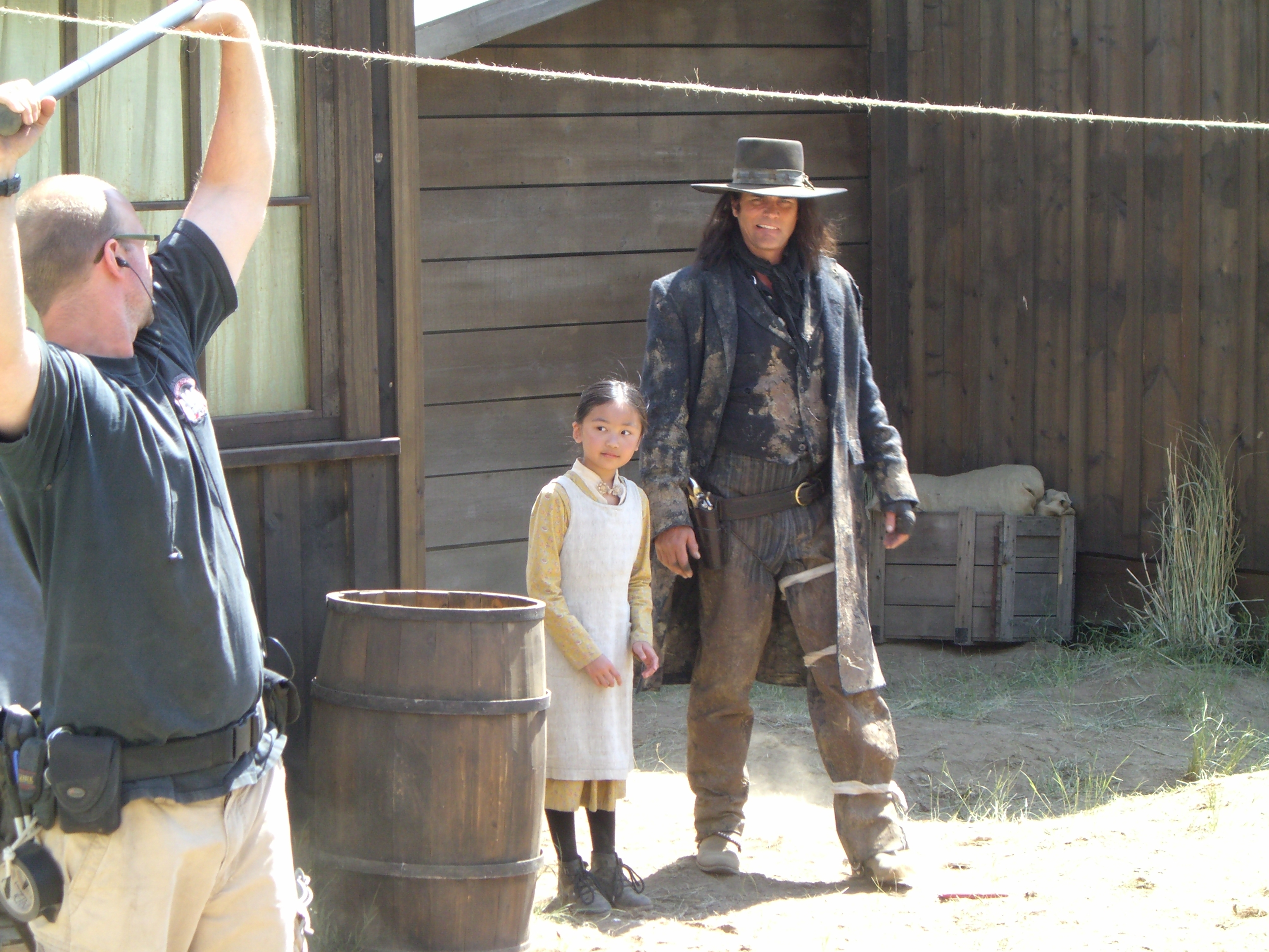 Melody as Adell Kwon with Paul Gross on the set of GUNLESS.