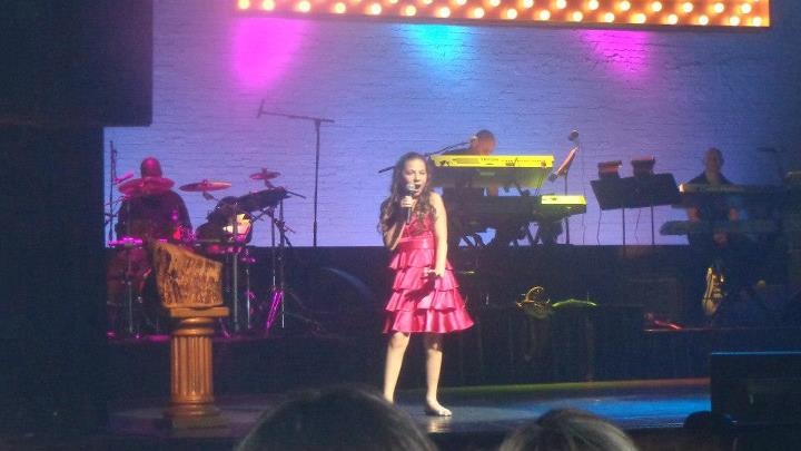 Rebecca singing on stage at the Apollo Theater