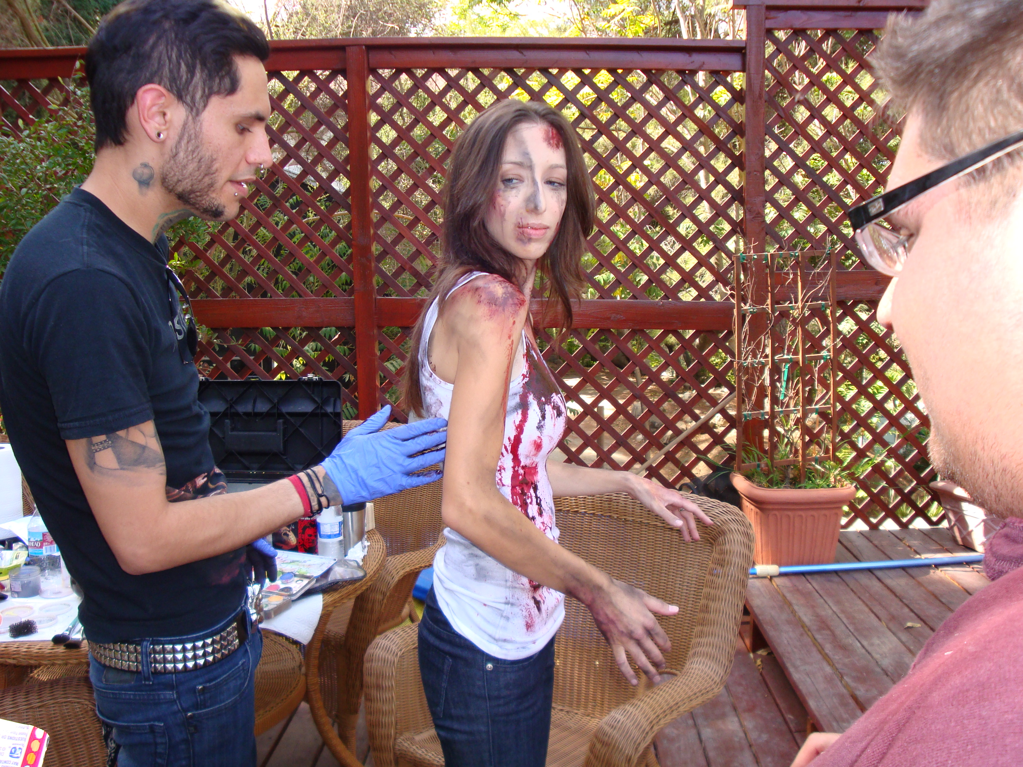 SFX Artist Gage Munster applies the last touch of make up as Director Ricardo Gonzales looks on.
