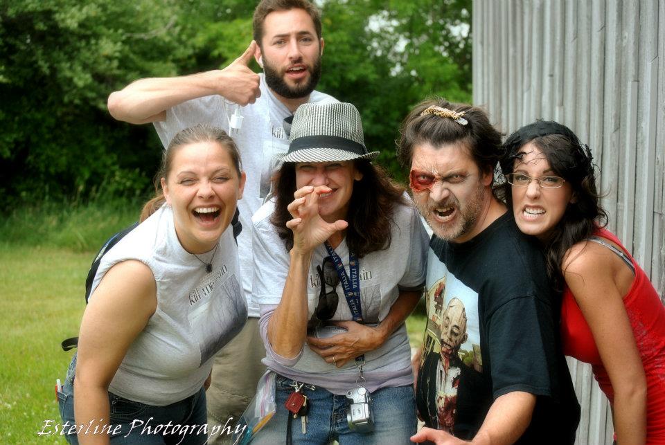 Some members of cast and crew together for a candid shot on the set of 'Kill Me Again'.