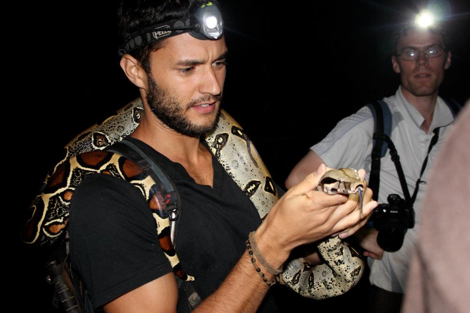 Taking measurements on a red-tailed boa during survey in Yachana, Ecuador.