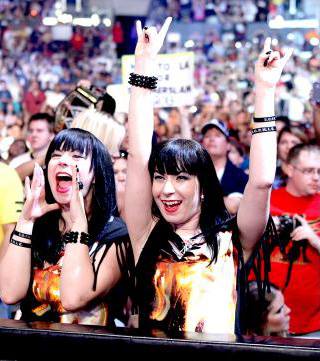 Sylvia (left) and her twin sister, Jen (right), ringside for SummerSlam 2013.