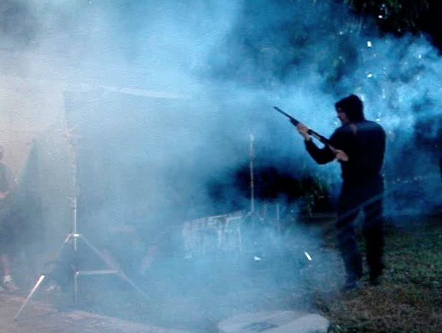 Behind the scenes: Jorge Ferragut plays the role of a felon in America's Most Wanted. Here, Jorge is firing a shotgun right into the camera, which is safely protected behind plexiglass.