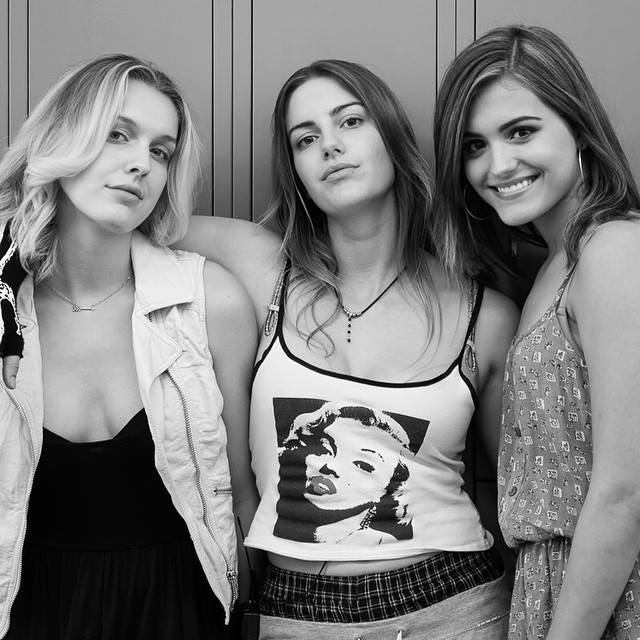 Jessica Lauren, Brianna Joy Chomer, and Alexandra Scott pose for a quick photo between takes on the set of 