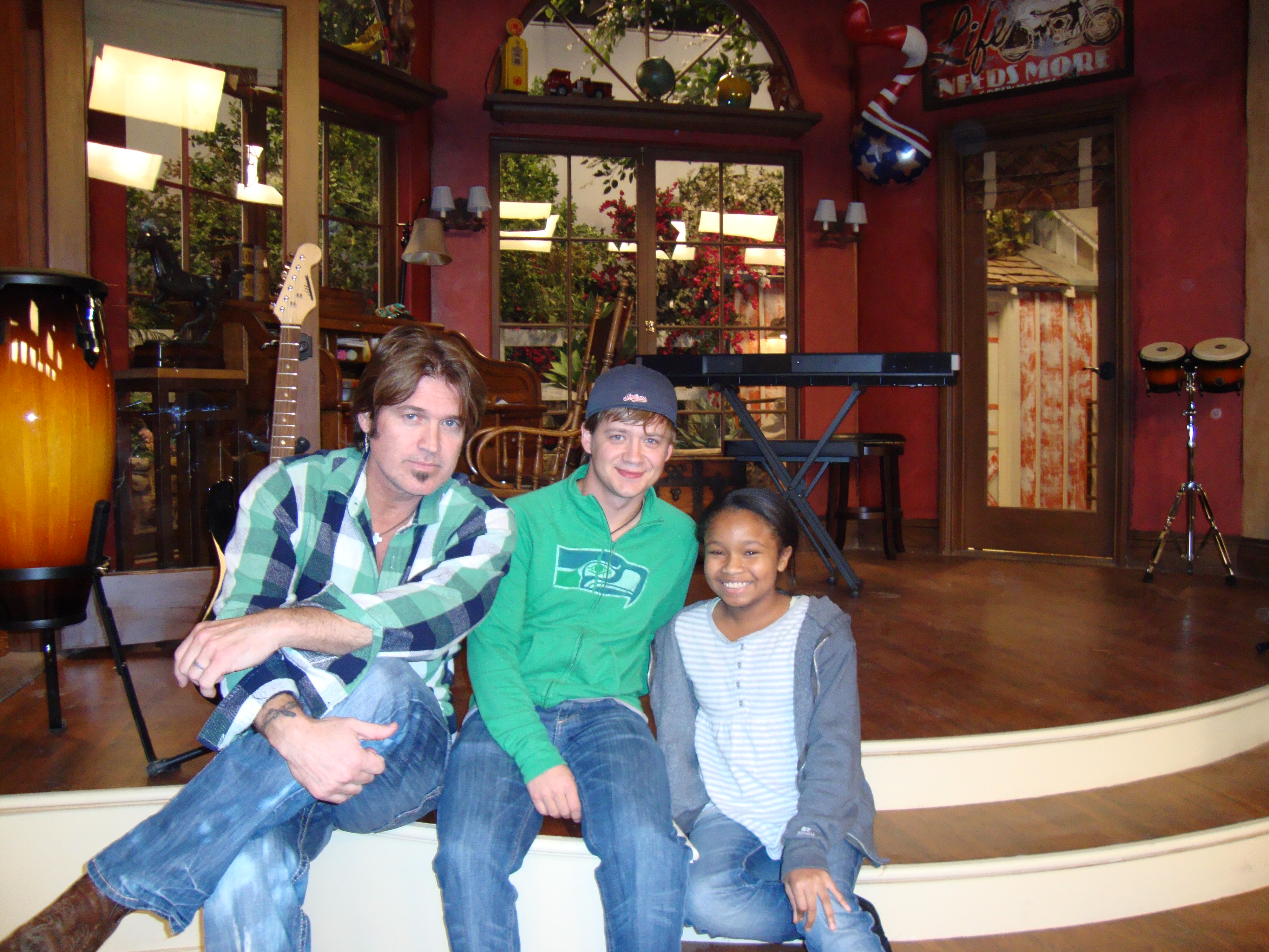 Kiara and Billy Ray Cyrus and Jason Earles on the set of 
