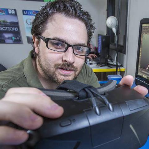 Tristan holding an Oculus VR devkit for the Arizona business Journal