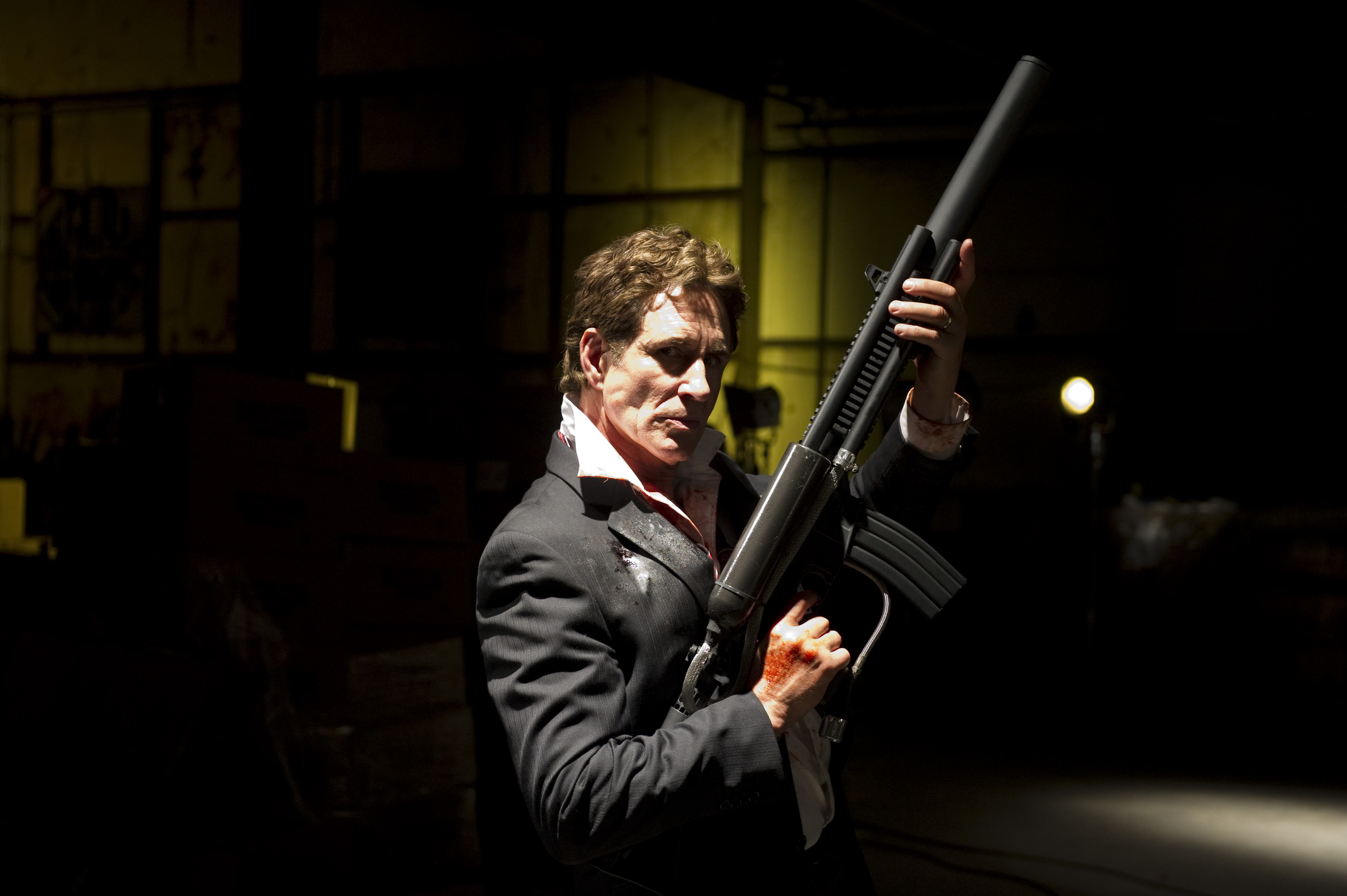 Actor John Shea poses with the hero weapon used in the film: 51. This weapon entitled The POW (pulse operating weapon) was built in 3 days and modeled after a air-blast rifle in 1960's. FYI: John loved posing with this weapon.