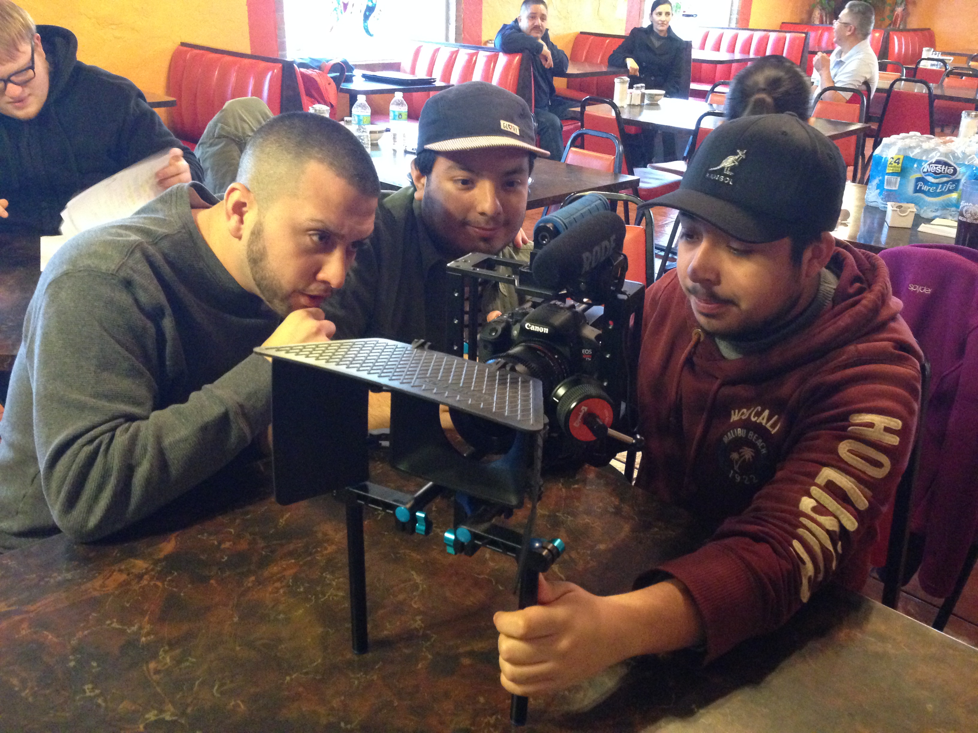 Thomas, David, and Alejandro watching the playback on the set of, 