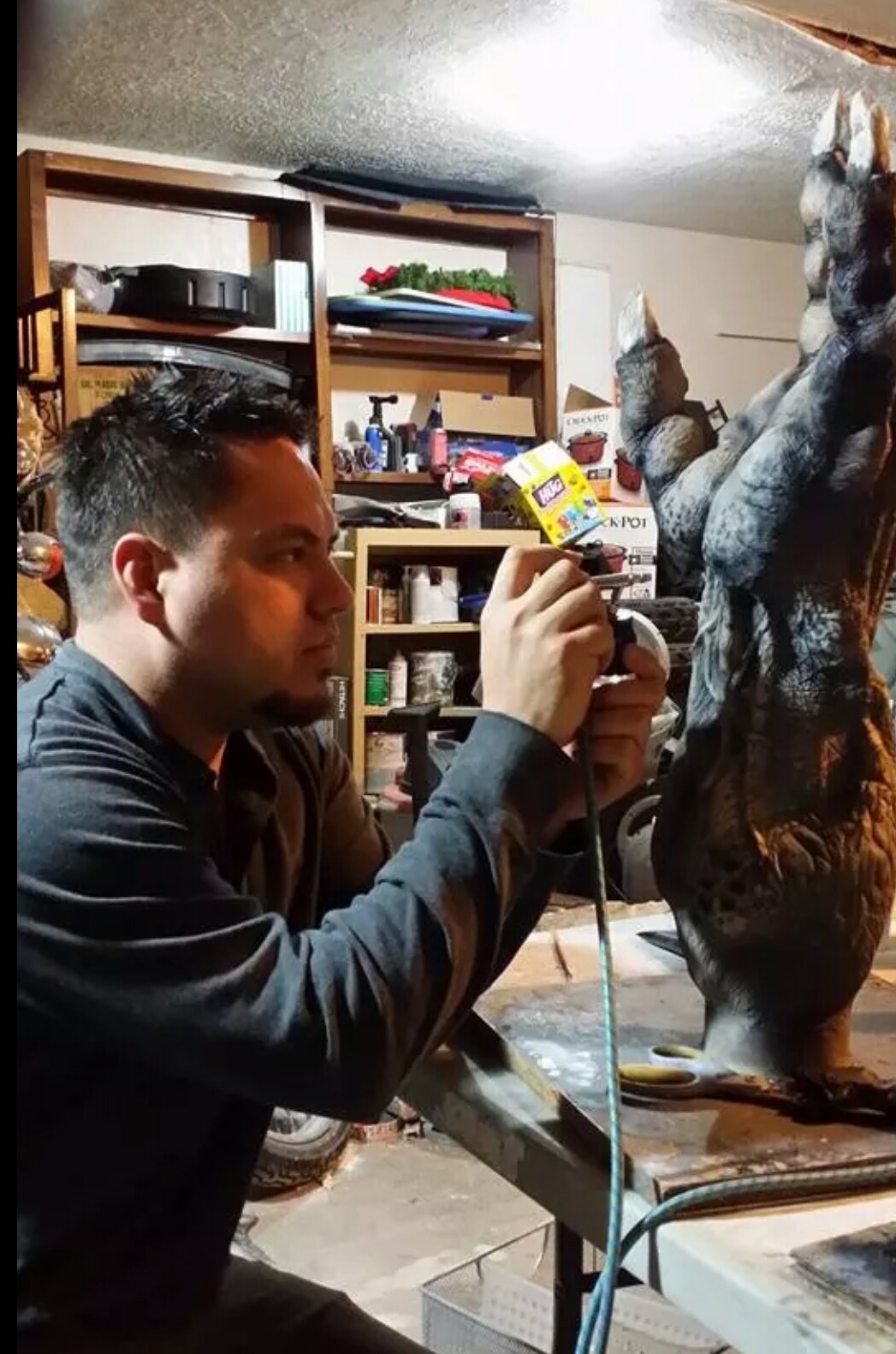 Daniel (DC) Casillas sculpting a 3-foot creature arm