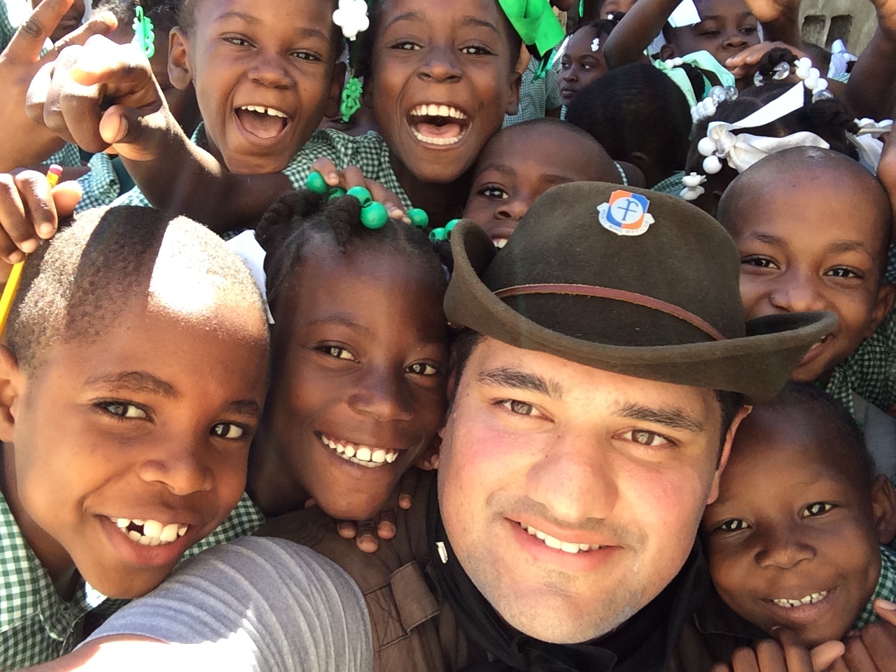 Joseph Cinemato with a group of Haitian school children in the Slums of Cite Soleil, Porta Prince in Haiti.