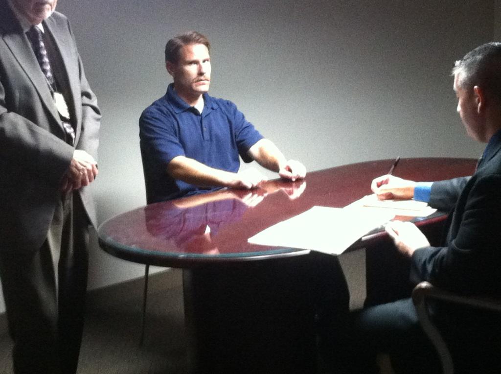 Screen grab of Jack Mahrt on the set of Unusual Suspects, playing Warren Mackey, under interrogation