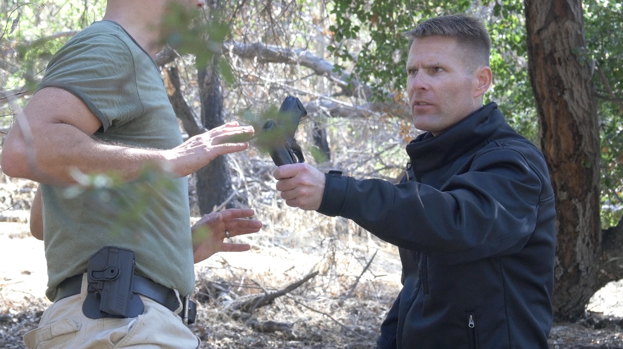 Screen Shot: Agent Rimes, (Mahrt), hands Sgt. Lanson, (Von Halle), his gun back on the set of 