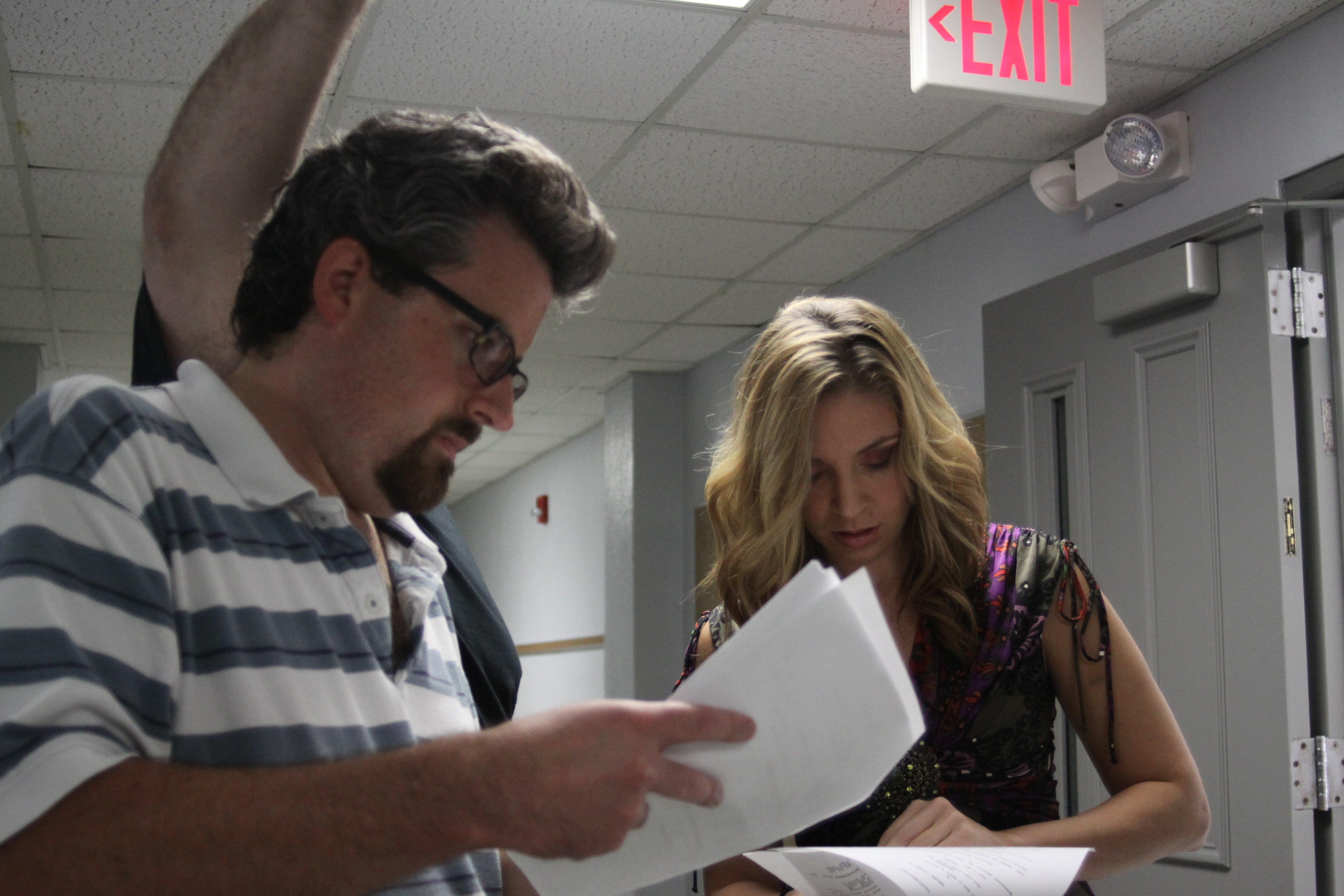 Ted Souppa goes over lines with Emily Cutting on the set of Hide.