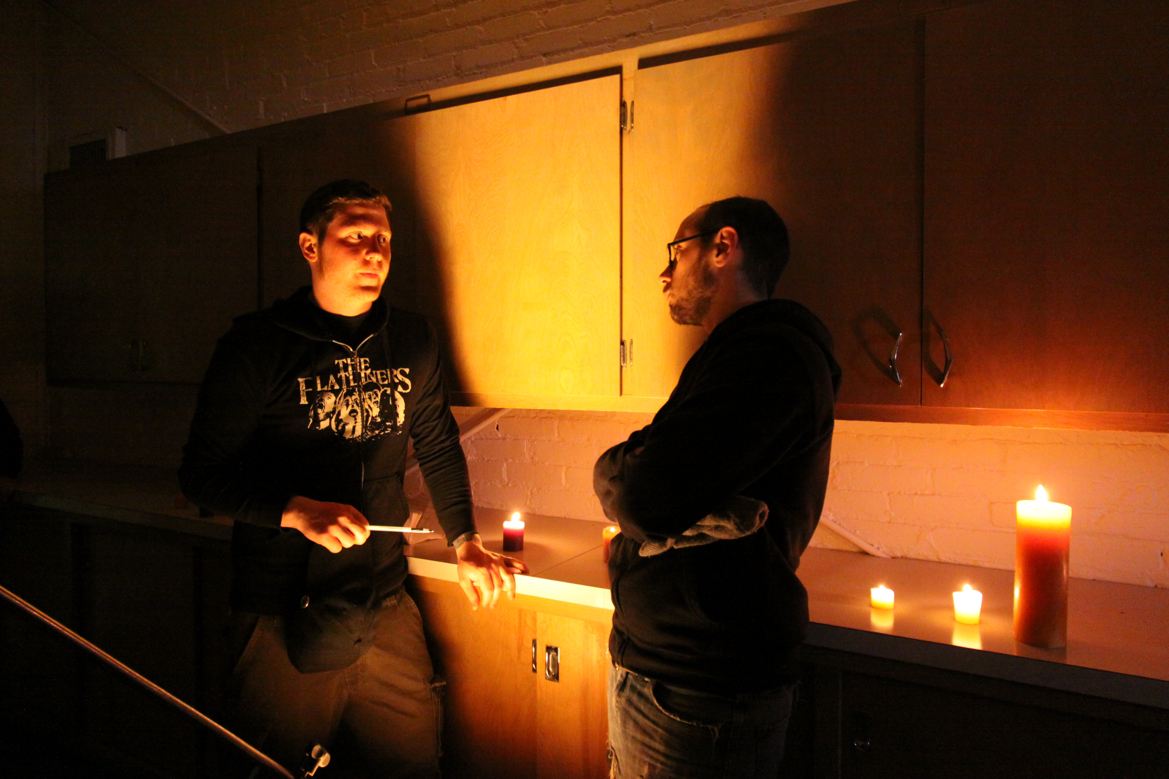 Co-writer/co-director team John Pata and Adam Bartlett stand in while director of photography Travis Auclair adjusts lighting on the set of Dead Weight.
