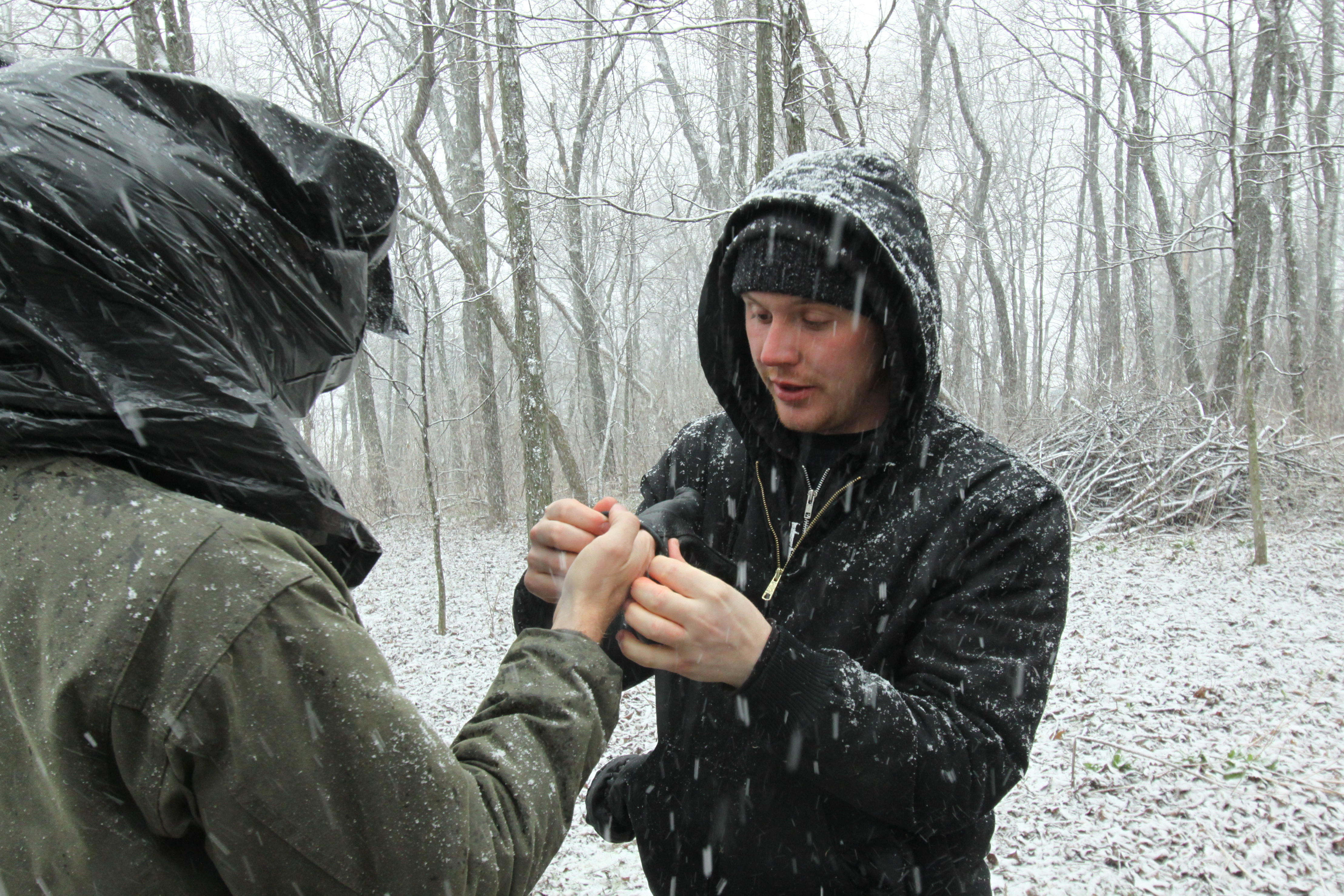 Assisting director of photography, Travis Auclair, put his glove on while filming during a blizzard.