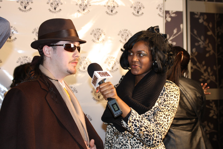 Che being interviewed on the red carpet at the Atlanta premiere of Breaking Up Is Hard To Do.