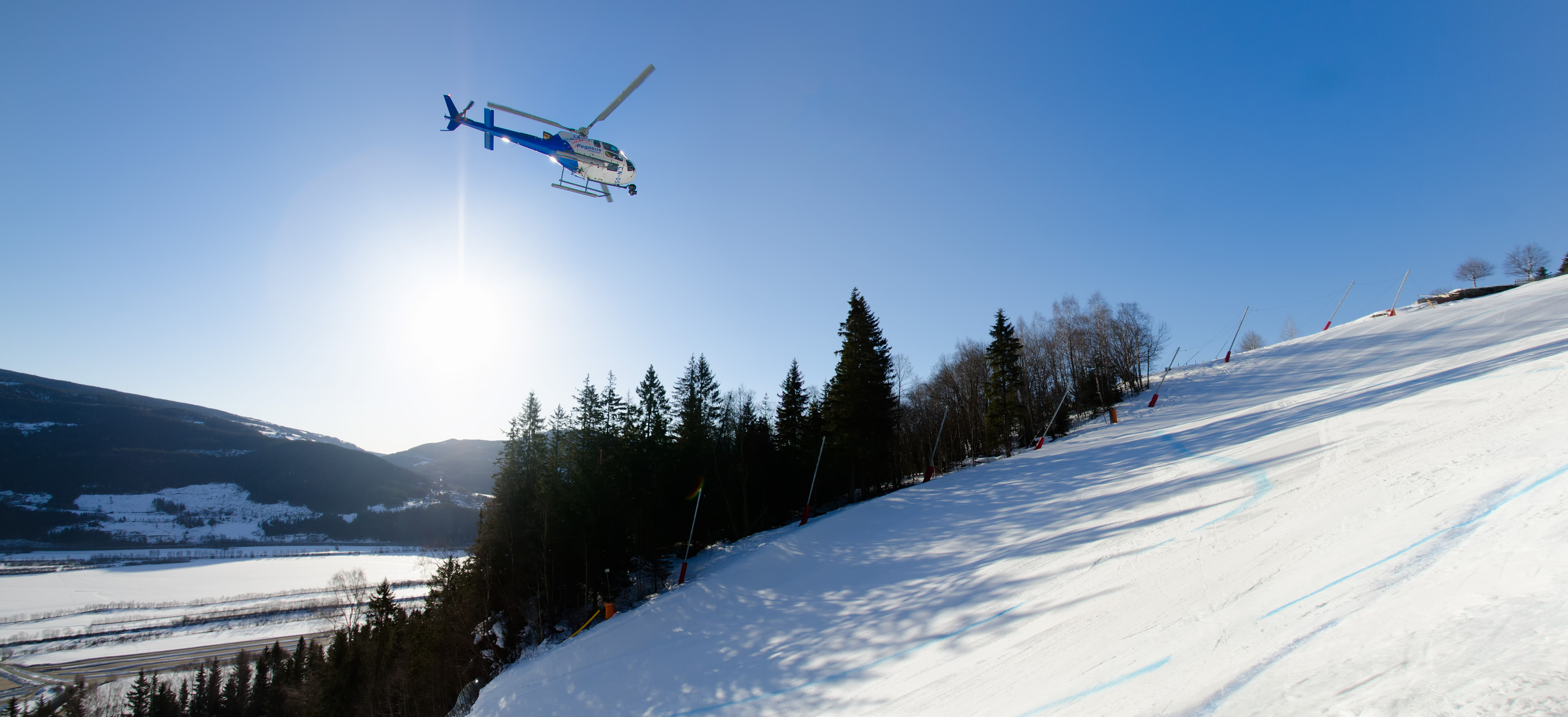 Pegasus Helicopter on aerial mission on Kvitfjell Alpine Center Norway. Filming World Cup winner Aksel Lund Svindal, for Antimedia