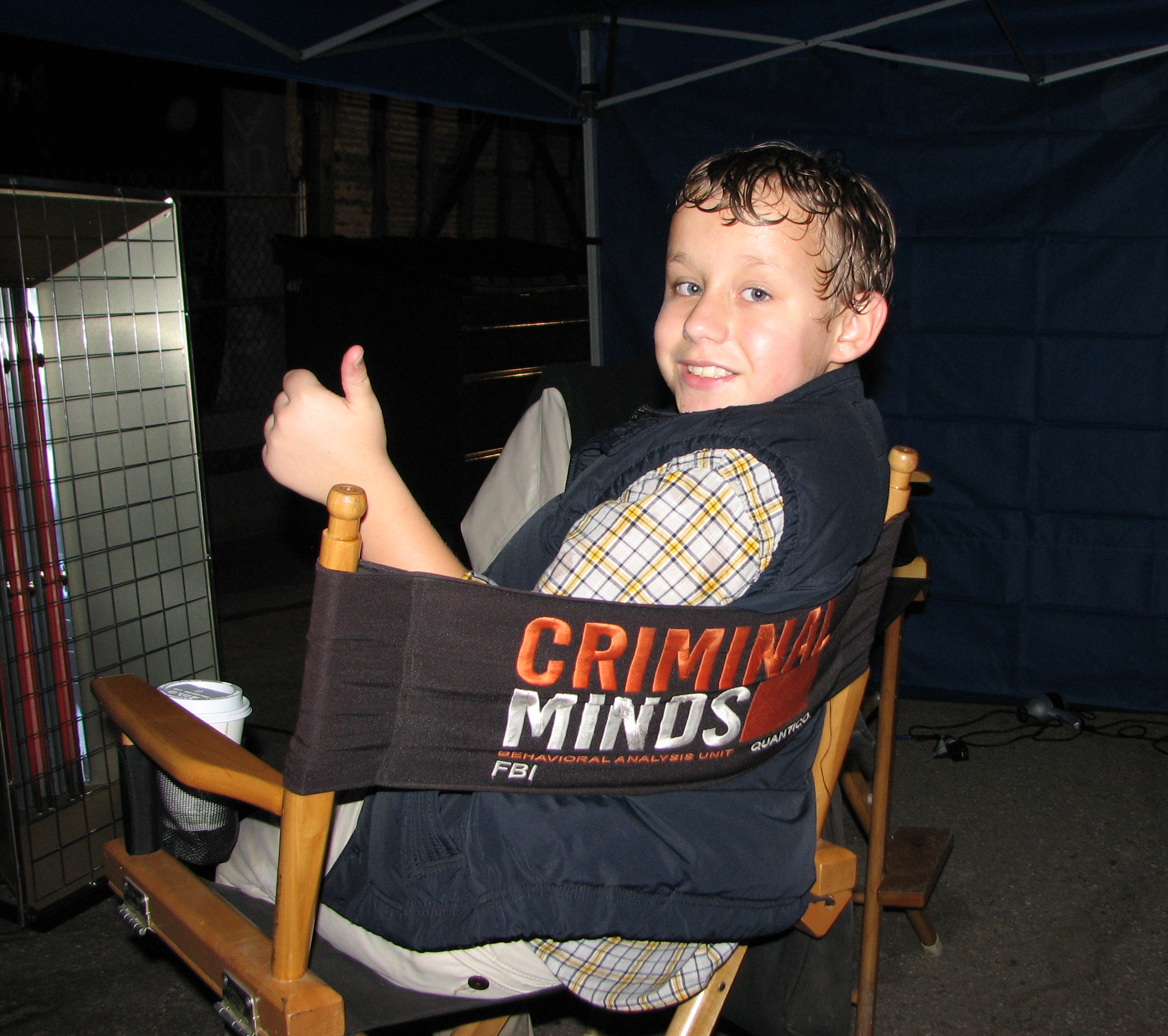 Carsen Warner on the set of Criminal Minds. Warming up a bit while working in the rain.