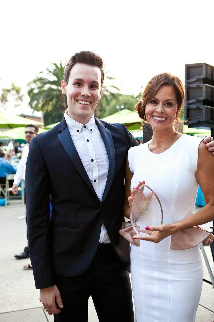 Television host Matthew Hoffman presents Brooke Burke Charvet with an award at the American Cancer Society Gala