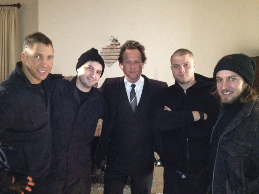 on set with the cast from an ALLSTATE commercial. In the middle is Dean Winters(OZ, 30 Rock, etc) aka 'Mayhem'