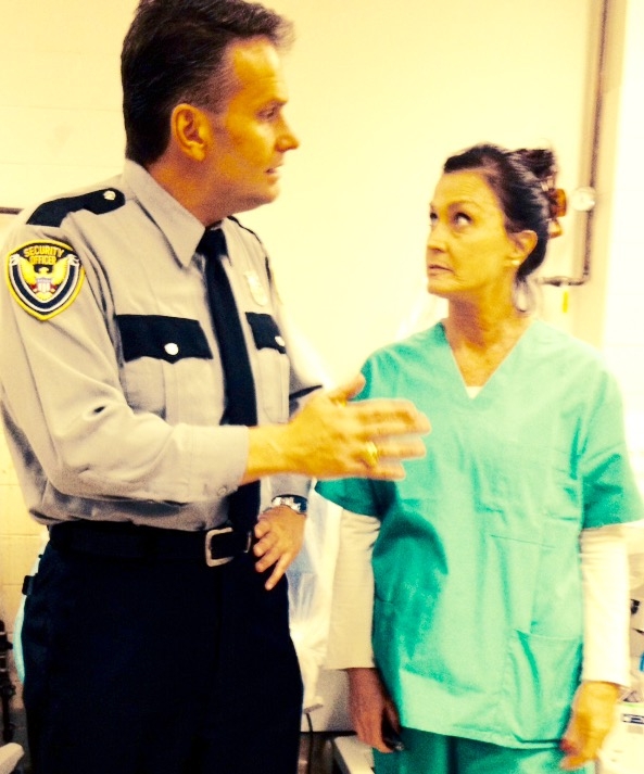 As no nonsense ER guard in TV Show Odd Mom Out, - off set pic.
