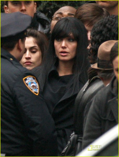 WITH ANGELINA JOLIE IN SALT CHOSEN BY DIRECTOR PHILLIP NOYCE TO BACK HER UP IN CROWD WEARING BROWN STETSON HAT.