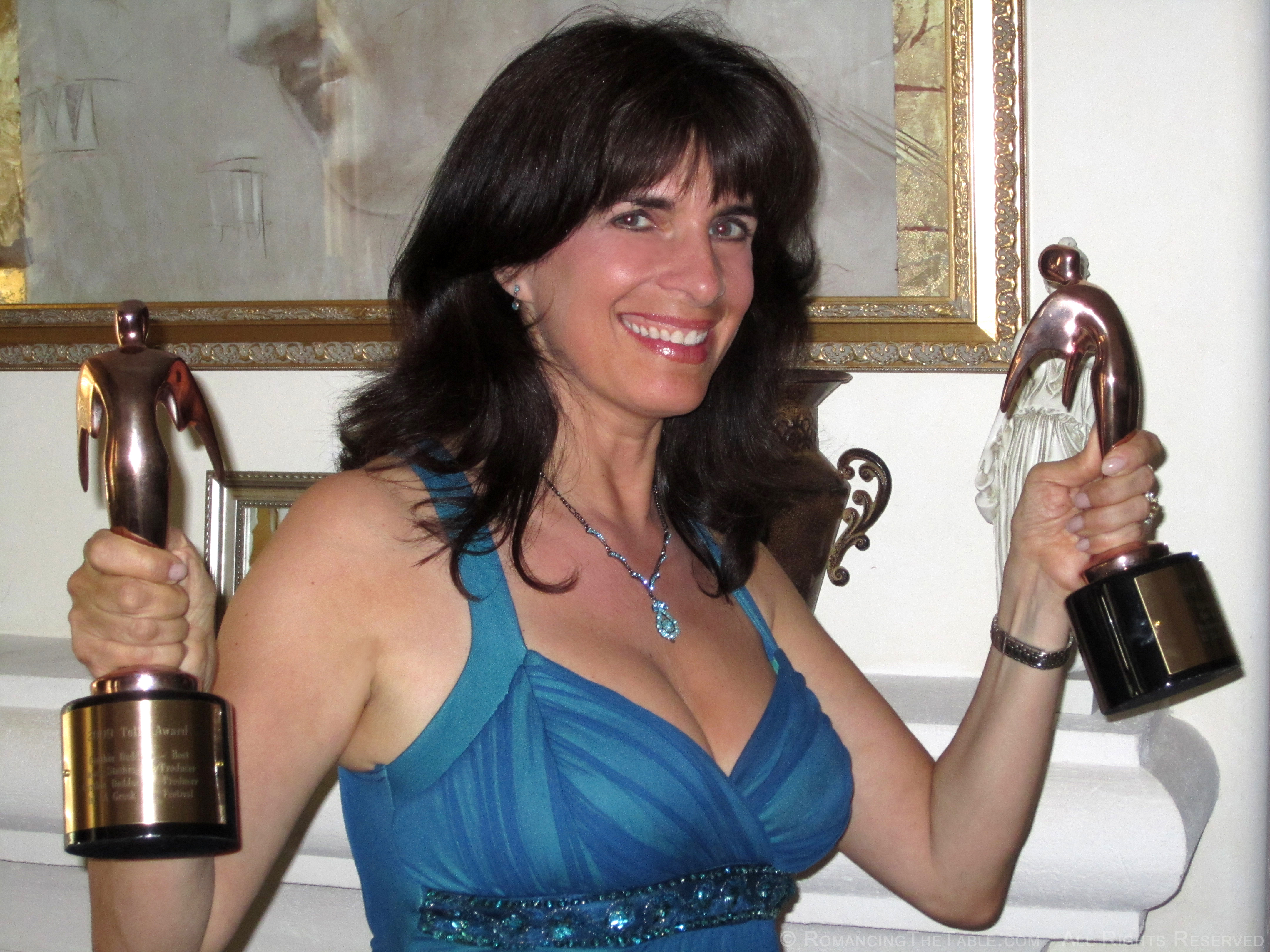 Cynthia Daddona at home working out with her two Telly Awards.