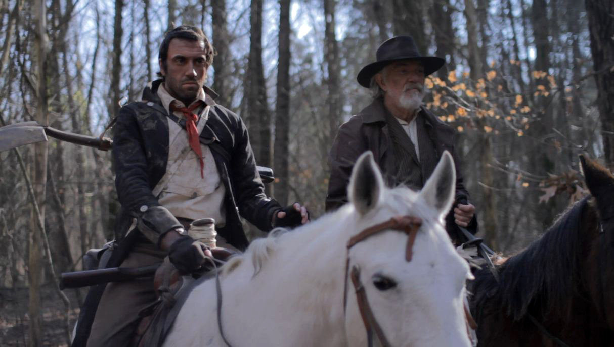 The Preacher (Daniel Van Thomas) and Edwards (Daniel Britt) on horseback. (Official Still)
