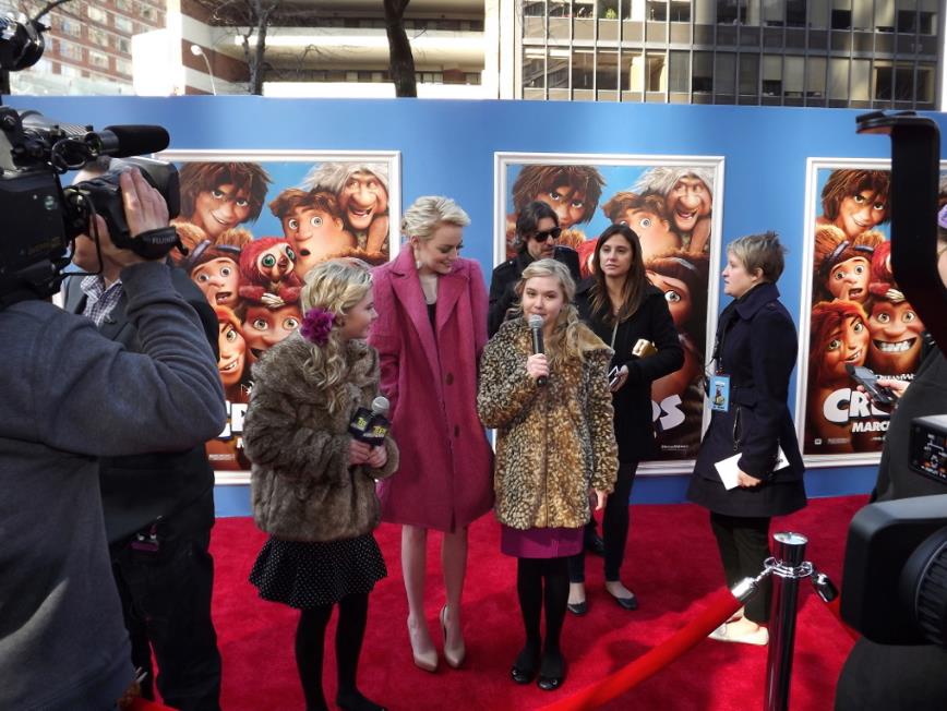 Cailin Loesch (left) and twin sister Hannah Loesch interviewing Emma Stone at the NYC film premiere of The Croods