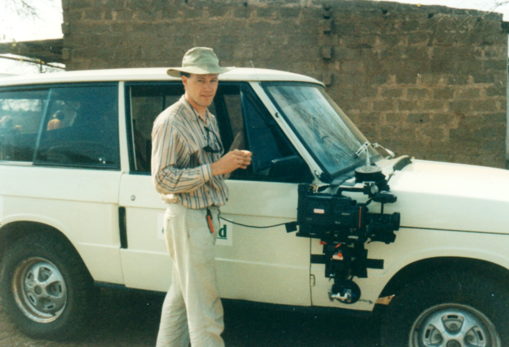 Philip Taylor as a young film Director in prepares for a travelling shot in Kenya